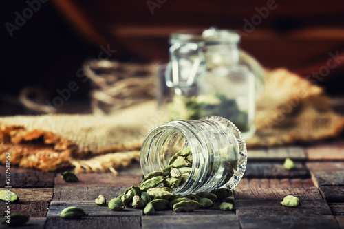 Dry whole cardamom, vintage wooden background, selective focus