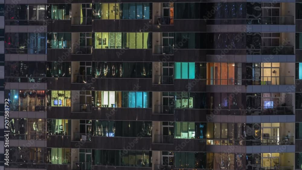 Windows of the multi-storey building of glass and steel lighting inside and moving people within timelapse Windows of the multi-storey building of glass and steel lighting inside and moving people within timelapse