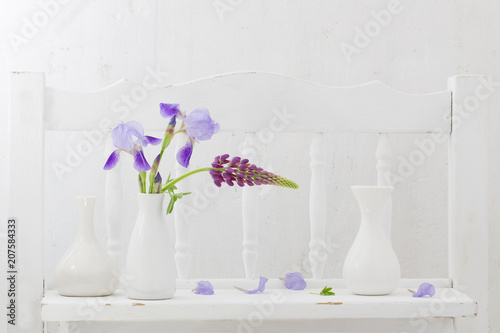Fototapeta Naklejka Na Ścianę i Meble -  blue flowers in vase on white wooden shelf