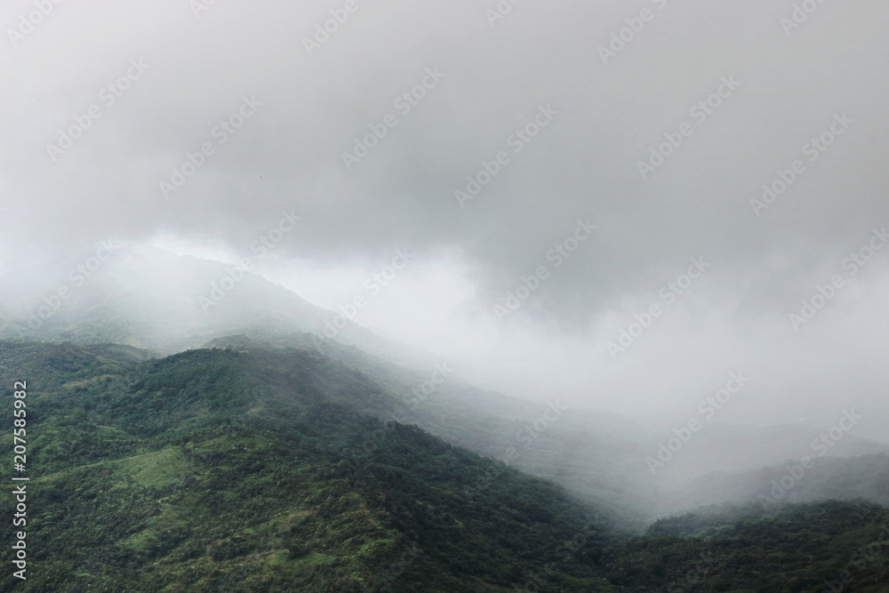 Moody fog over mountain scenery in rainy day.