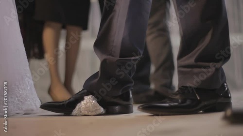A groom breaks a glass