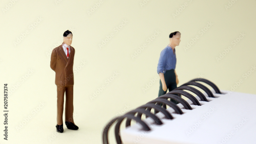 Obraz premium Miniature men and wire bound&nbsp;notebook&nbsp;pad.