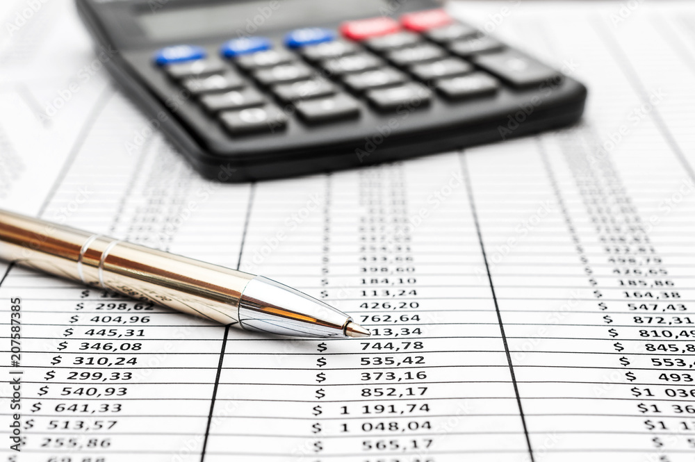 Pen with calculator on document with financial data. Business concept. Pen with calculator on document with financial data. Business concept.