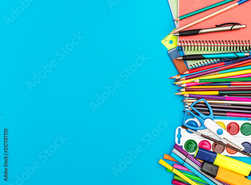Frame from school supplies on blue background. Education background.