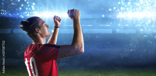 Happy soccer player with goal joy in the 3d imaginary stadium background