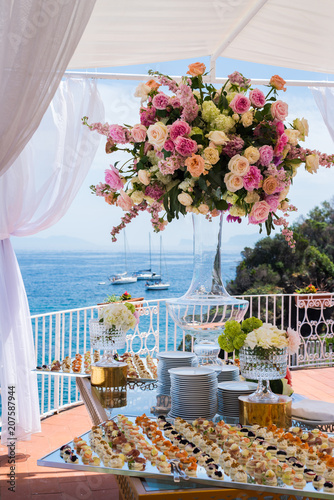 Beautiful flowers and wedding table decorations with with ocean and boats view