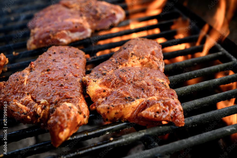 grilled pork with flames on barbecue grilled pork with flames on barbecue
