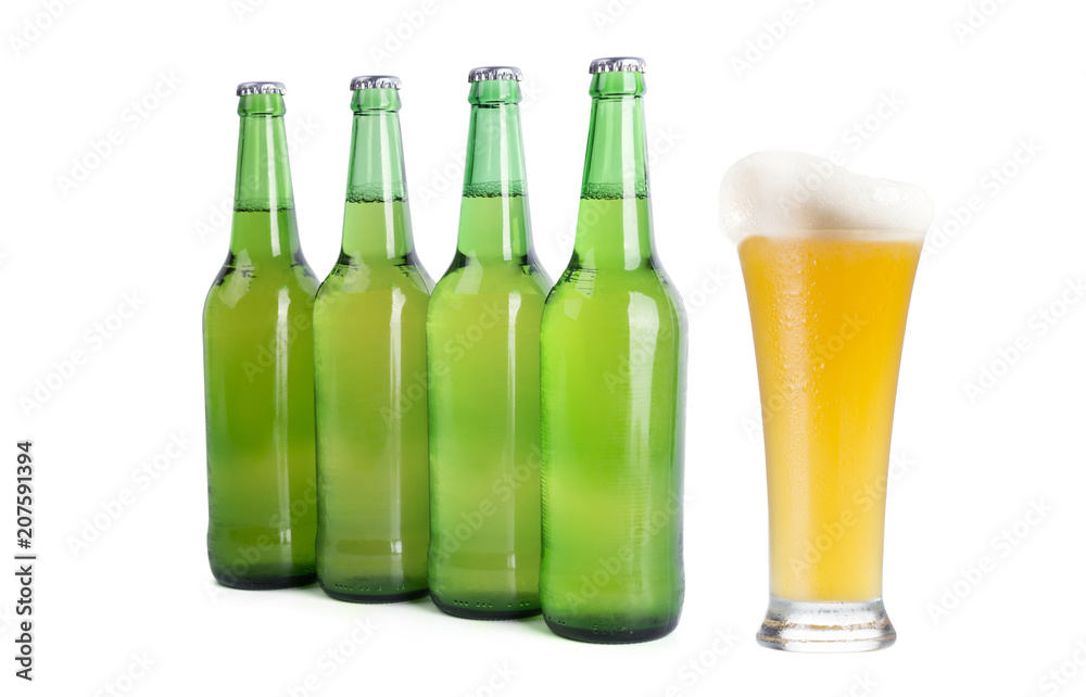 Four Green Beer Bottles and One Full Glass of Beer on a white background. Four Green Beer Bottles and One Full Glass of Beer on a white background.
