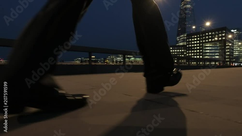 Low angle view of a businessman walking at dusk