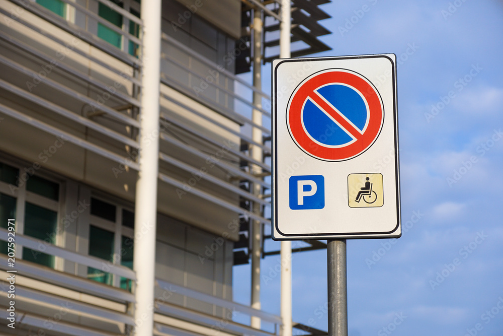 handicapped sign mark parking spot, disabled parking permit sign on pole with convenience store in gas station area background, copy space