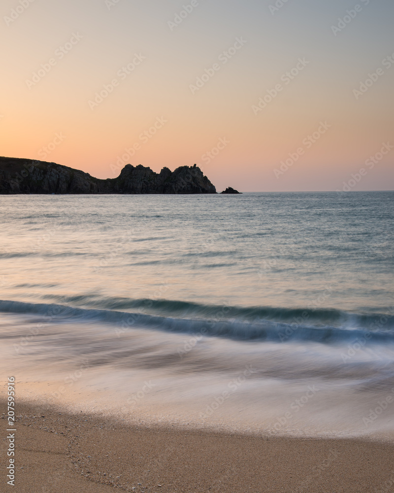 Stunning vibrant sunrise landscape image of Porthcurno beach on South Cornwall coast in England