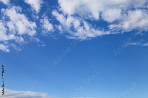 Blue sky with white clouds, space for text