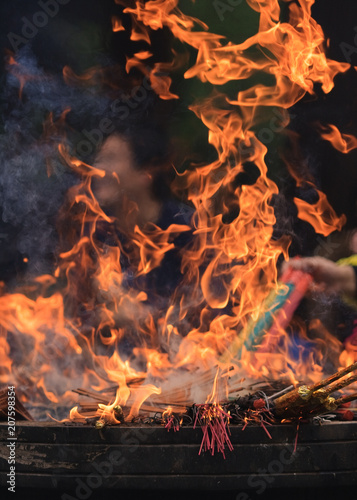 Flames of burning incense in an altar of a Buddhist temple, Hangzhou, China.