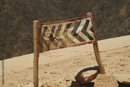 Danger - bend in the road sign on a mountain