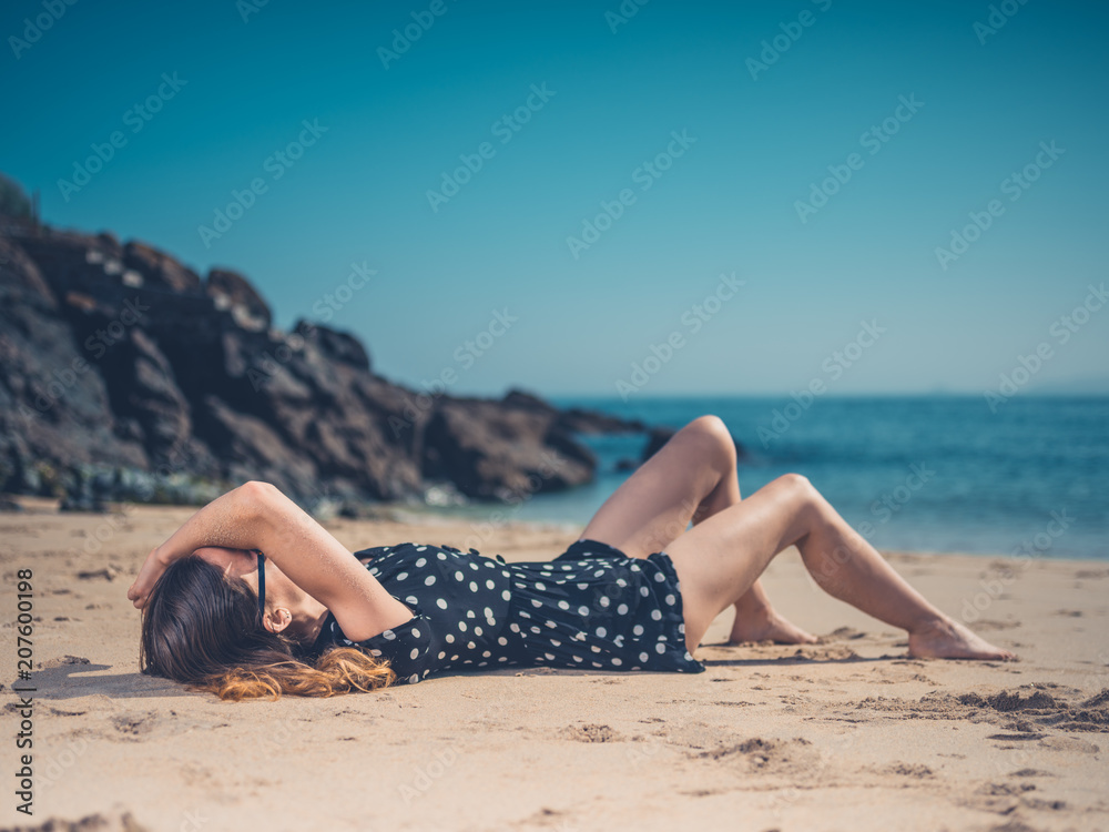 Beautiful young woman relaxing on the beach Beautiful young woman relaxing on the beach