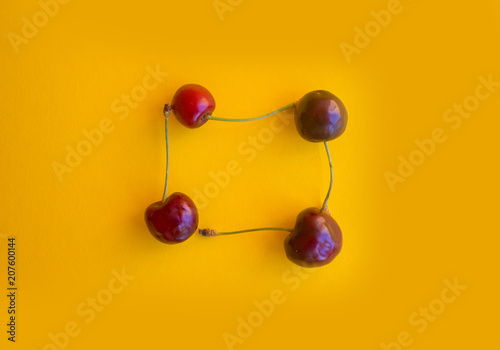 Berry of a cherry on a yellow background. Summer Fruit
