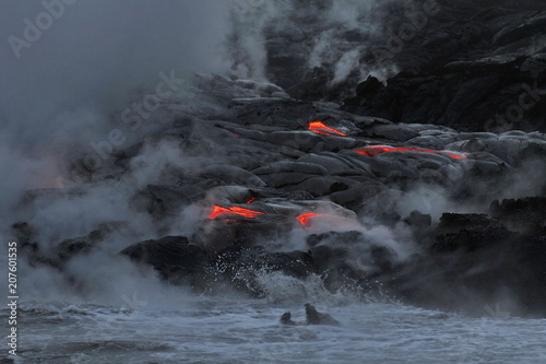 The lava of Kilauea volcano flows into the Pacific Ocean