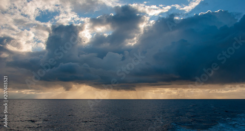 Mid Atlantic seascape  blue sky and clouds with a rain squall approaching.