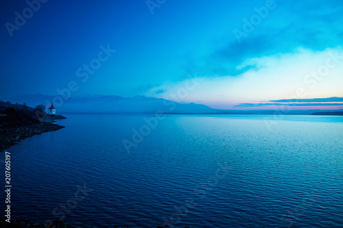 beautiful morning landscape with lake and church.