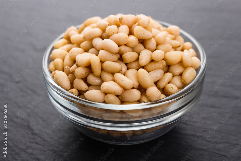 peeled pine nuts on a rustic background peeled pine nuts on a rustic background