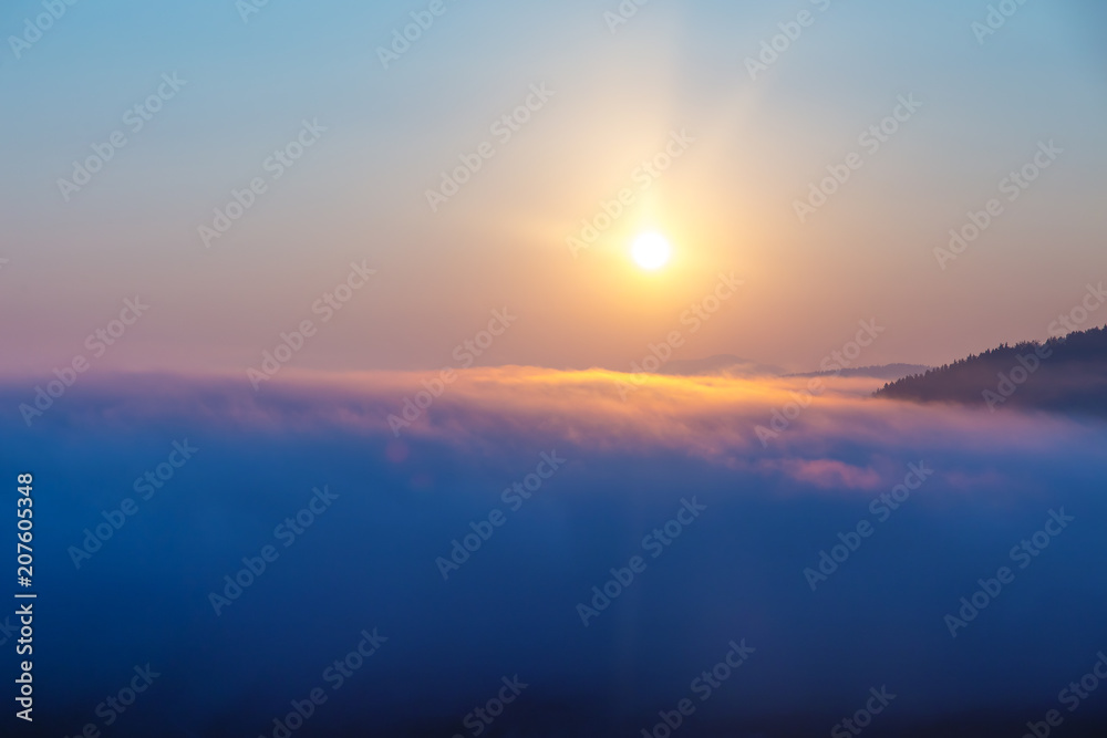 A beautiful morning landscape with sunshine and fog.