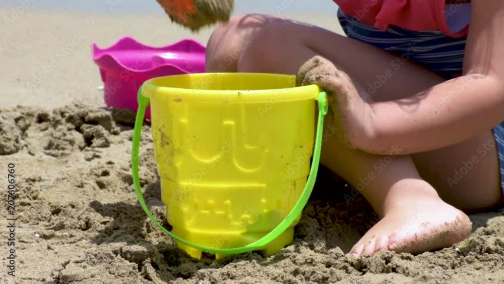 Closeup of a girl building castles in the sand Closeup of a girl building castles in the sand