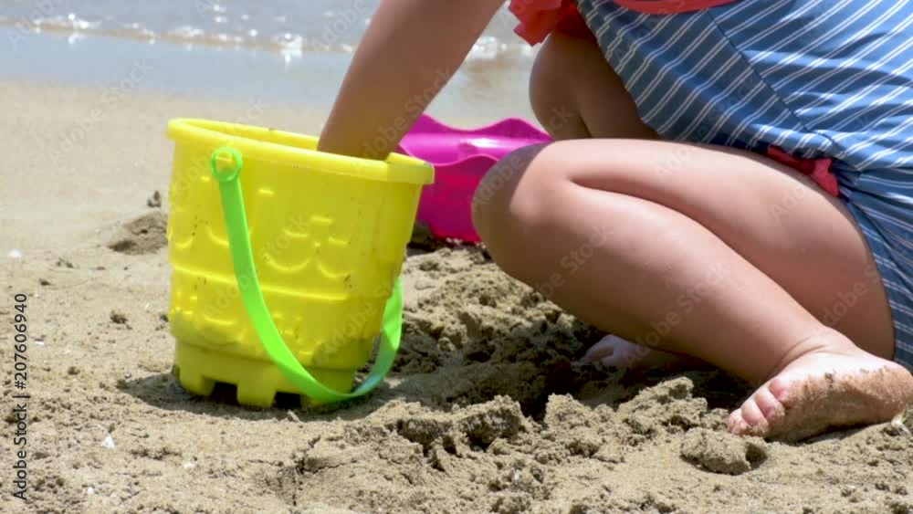 Closeup of a girl building castles in the sand Closeup of a girl building castles in the sand