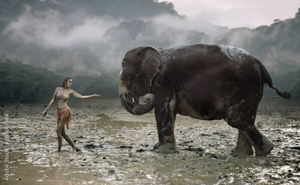 Fototapeta premium Conceptual portrait of a young tamer with an elephant