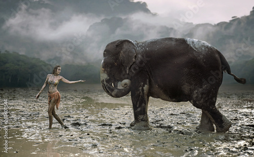 Conceptual portrait of a young tamer with an elephant