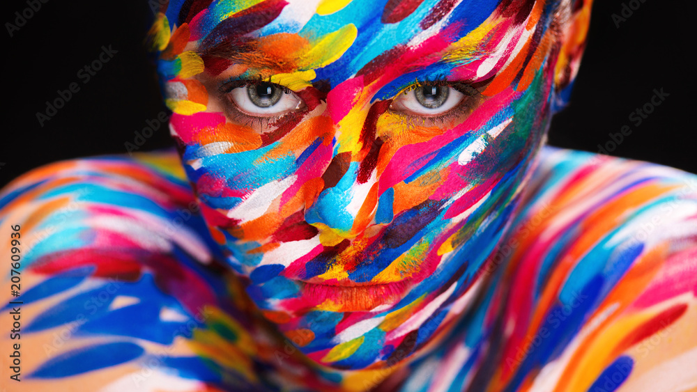 Portrait of the bright beautiful girl with art colorful make-up and bodyart