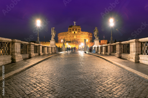 Night view of Saint Angel Castle and bridge over the Tiber river in Rome, Italy. Night cityscape of Rome.  