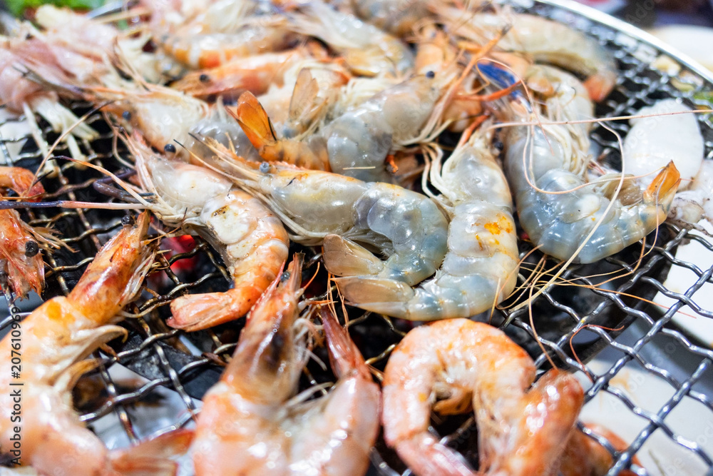 Orange grilled shrimp and shellfish on charcoal stove , bbq seafood . Orange grilled shrimp and shellfish on charcoal stove , bbq seafood .