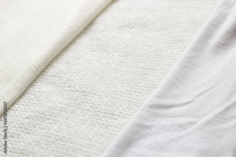 Close-up crumpled white textile for background. Different textures of fabrics with folds. Top view. Close-up crumpled white textile for background. Different textures of fabrics with folds. Top view.