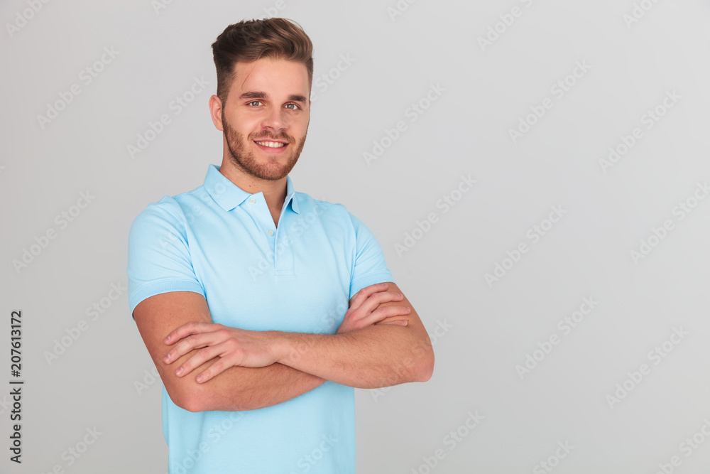 portrait of confident young man wearing light blue polo t-shirt portrait of confident young man wearing light blue polo t-shirt