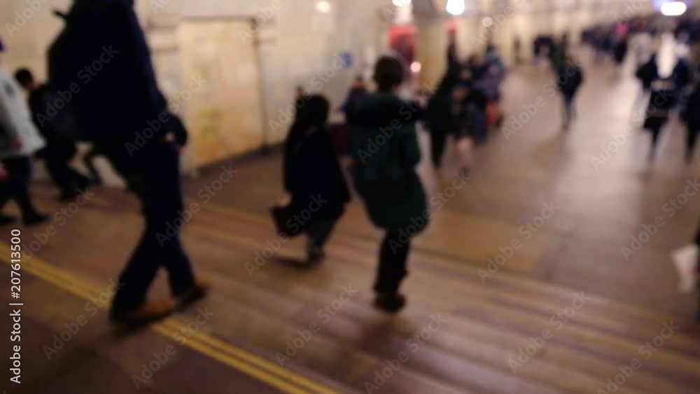 Commuters walking in the transit in subway station Commuters walking in the transit in subway station
