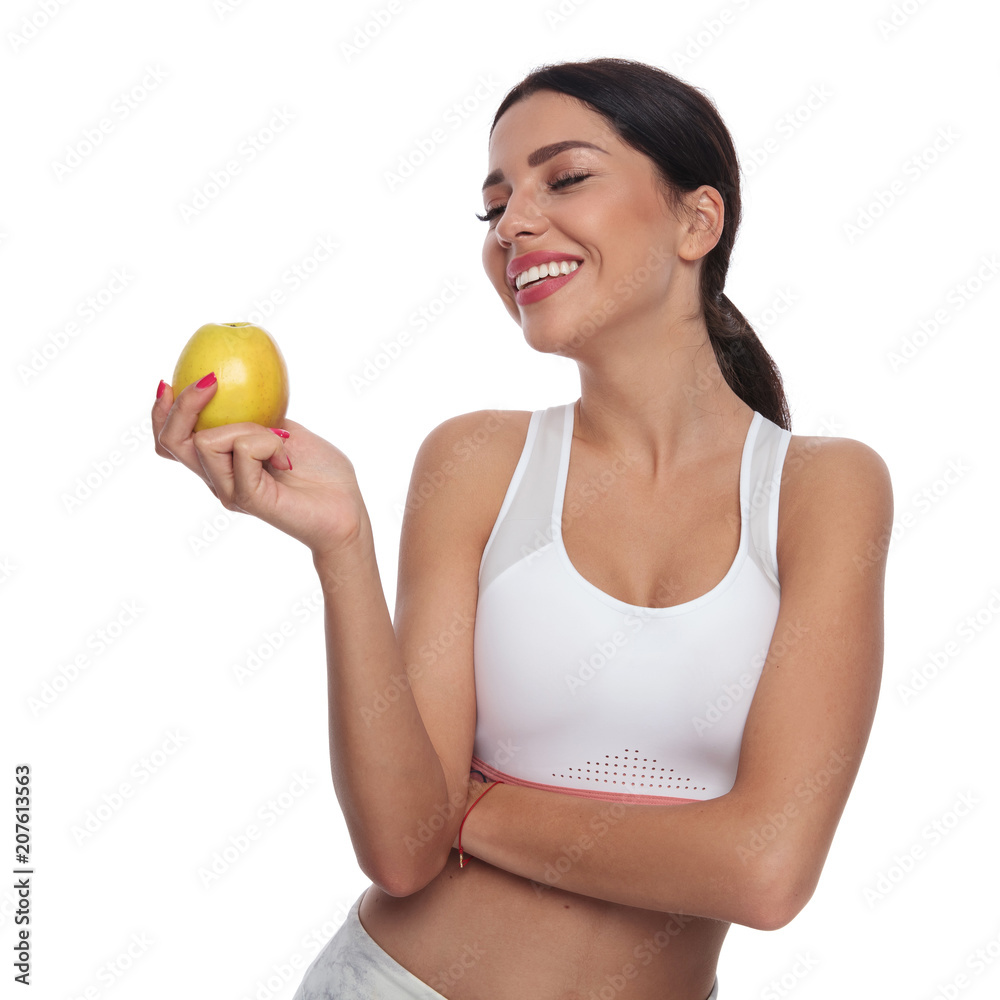 portrait of healthy beautiful woman holding and looking at apple portrait of healthy beautiful woman holding and looking at apple
