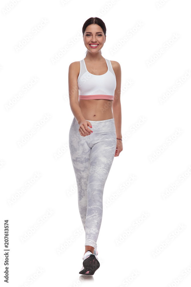 sexy fit woman walking forward to warm up for jogging sexy fit woman walking forward to warm up for jogging
