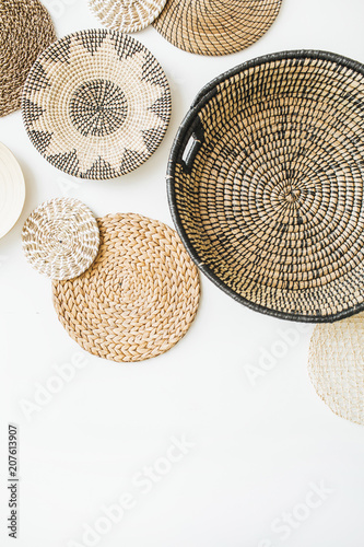 Decorative straw plates on white wall.