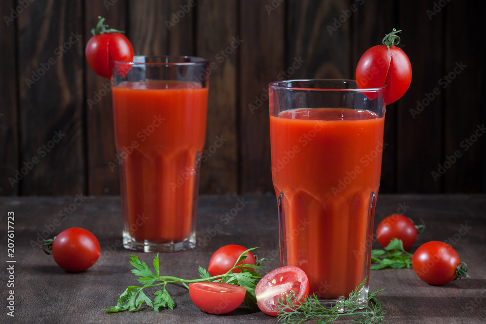 Tomato juice on dark wooden background Tomato juice on dark wooden background