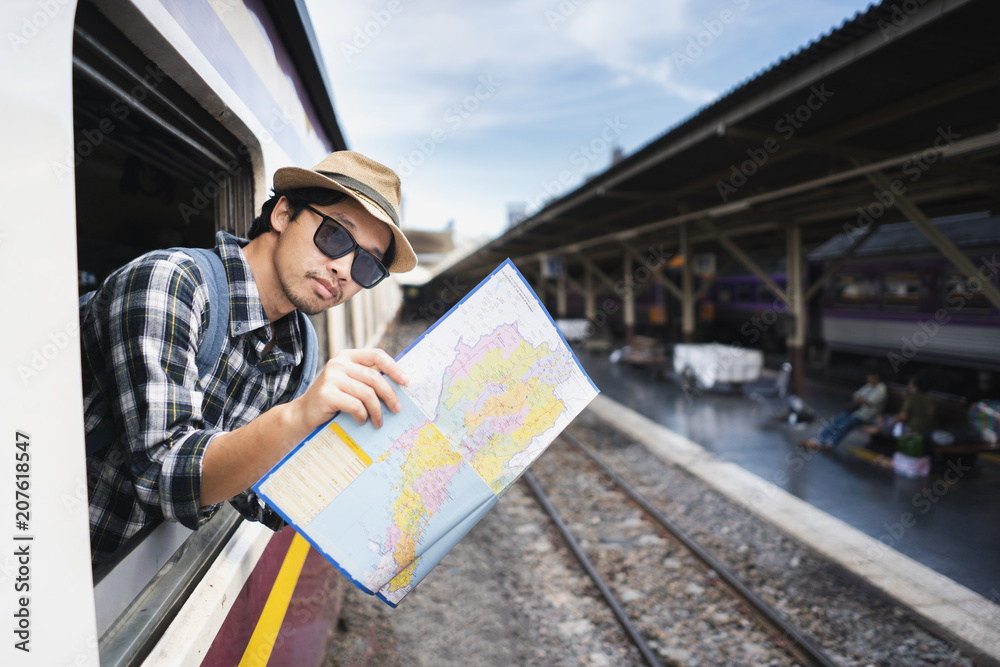 Asian man bag pack tourist with map in railway station at Thailand. Asian man bag pack tourist with map in railway station at Thailand.