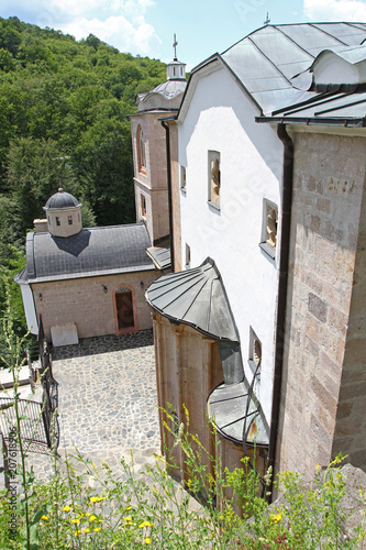 Church of Virgin Mary in a bright sunny day in east orthodox Monastery of St. Joachim of Osogovo, Kriva Palanka, Republic of Macedonia. The domes of a church. Christianity. Osogovo Monastery, vertical photo