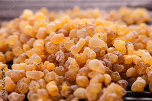 frankincense essential oil on a wooden background