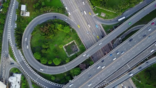 4K. Aerial view of highway road interchange with busy urban traffic speeding on the road. Junction network of transportation in Bangkok, Thailand. taken by drone	