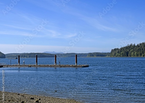 empty wooden pier on a sunny day with blue sky at Ucluelet harbour  Vancouver Island British Columbia Canada