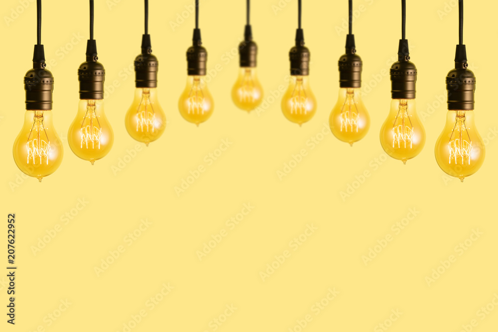 Edison light bulbs on yellow background. space for text Edison light bulbs on yellow background. space for text