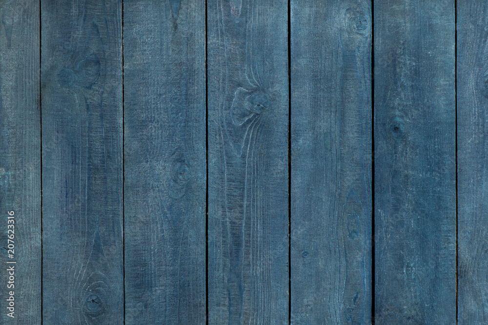 Fototapeta premium Faded blue wooden background. vertical