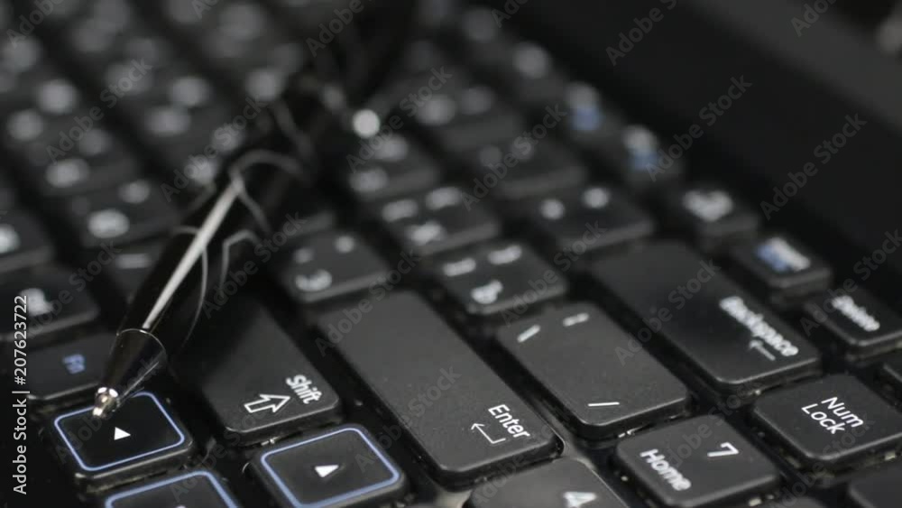 Selective focus with a pen on the laptop keyboard. Selective focus with a pen on the laptop keyboard.