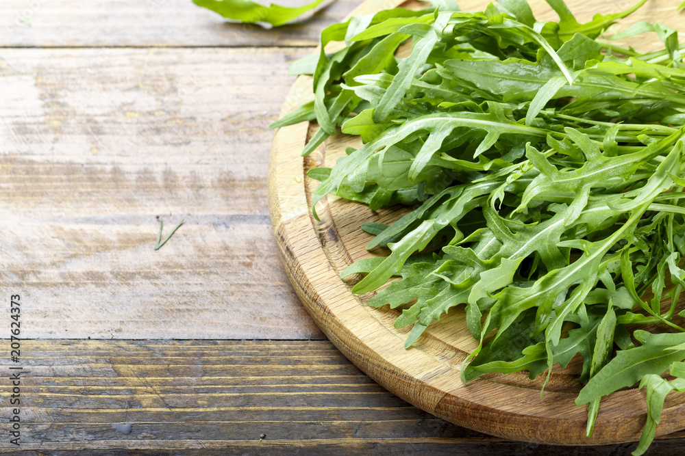 fresh arugula on a wooden background fresh arugula on a wooden background