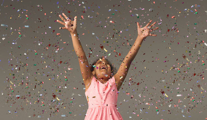 Happy black small girl at white studio background