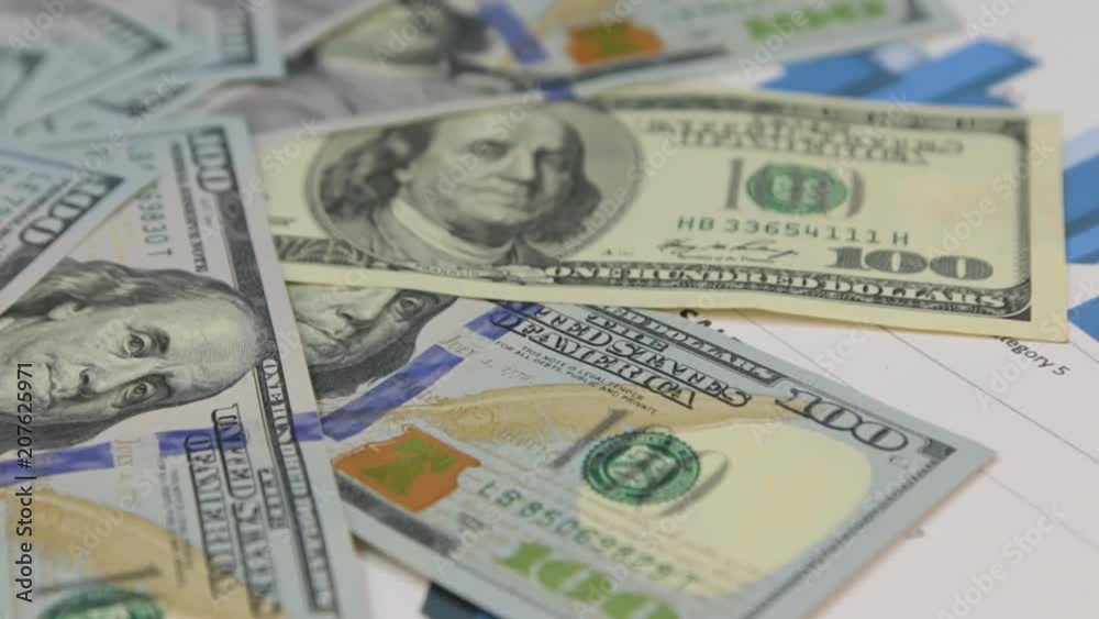 Rotation of dollars laid out in the form of a circle, lying on the diagrams. Rotation of dollars laid out in the form of a circle, lying on the diagrams.